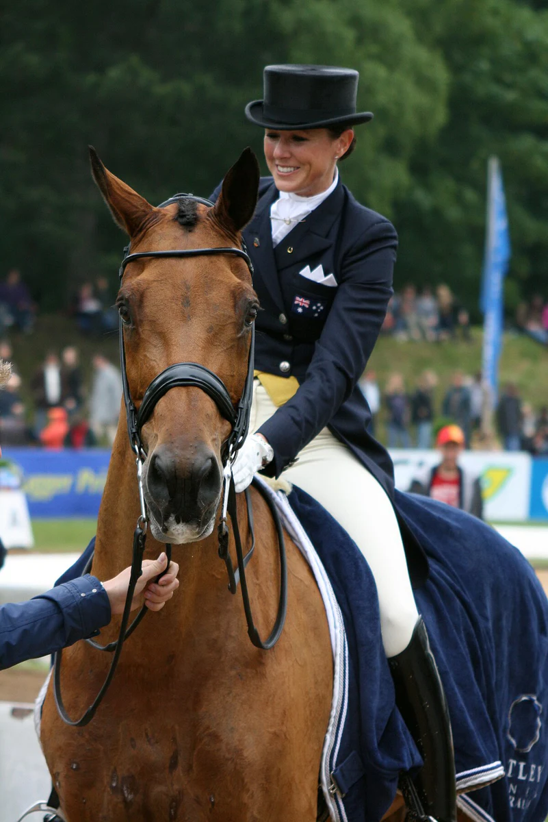Lyndal Oatley riding Potifar in a dressage competition arena at Pferd International