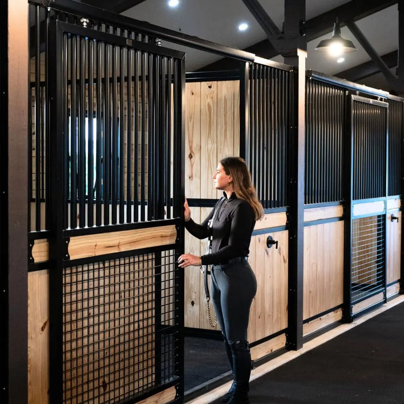 Luxury custom horse stalls with mesh stall fronts by American Stalls