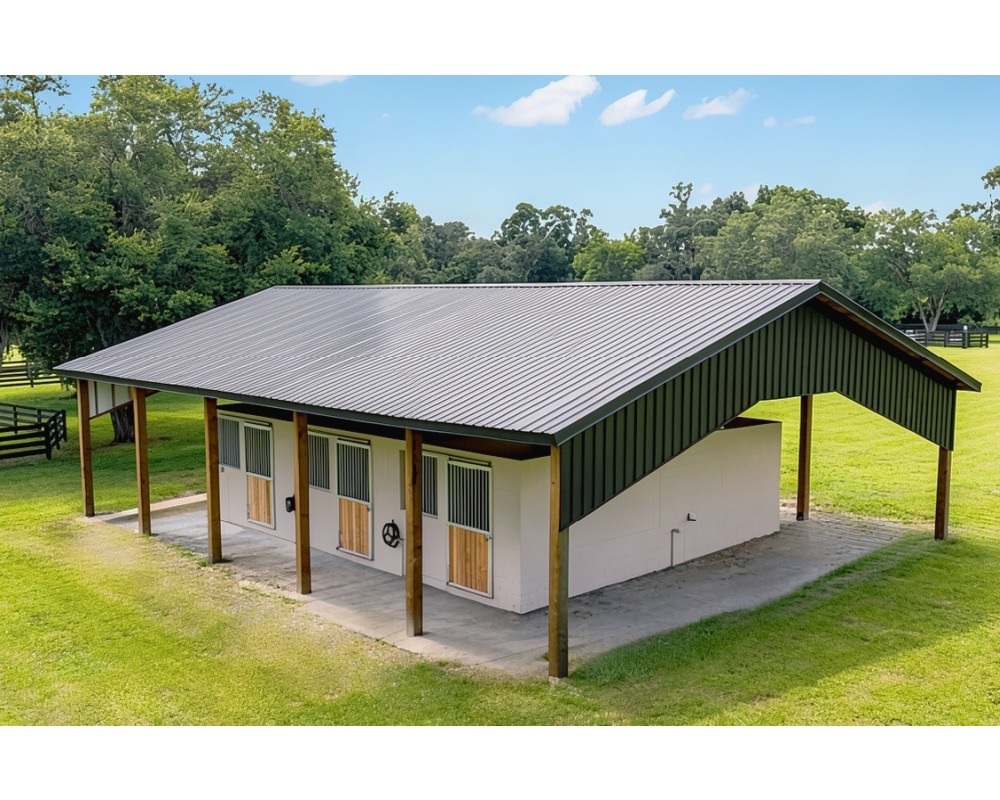 Aerial view of a modern center-aisle horse barn fitted with Armour aluminum stall fronts and Dutch doors
