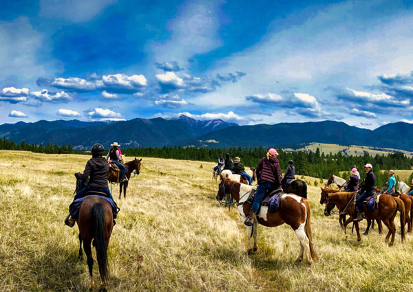 Guests on horseback trail rides at The Bar W Guest Ranch in Whitefish, MT