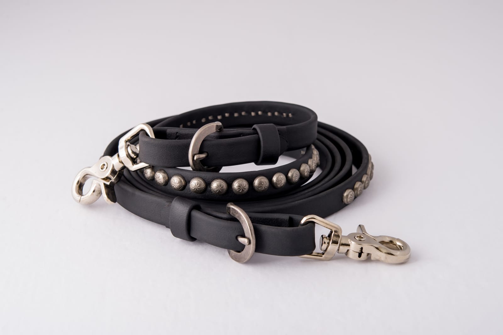 Black Dr. Cook Deluxe Beta trail rein with antiqued spots, swedge buckles and bit snaps