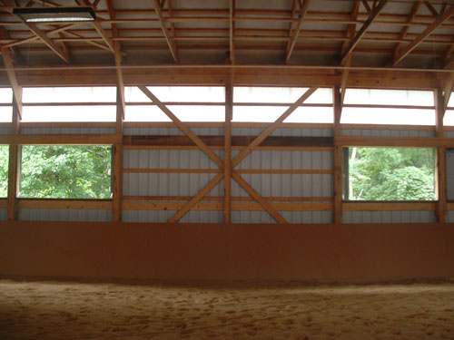 Tongue-and-groove rider guards inside a Blue Chip Structures indoor horse arena