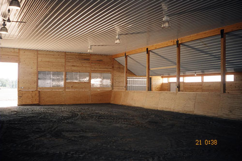 Slanted arena rider guards lining an indoor riding arena by Blue Chip Structures