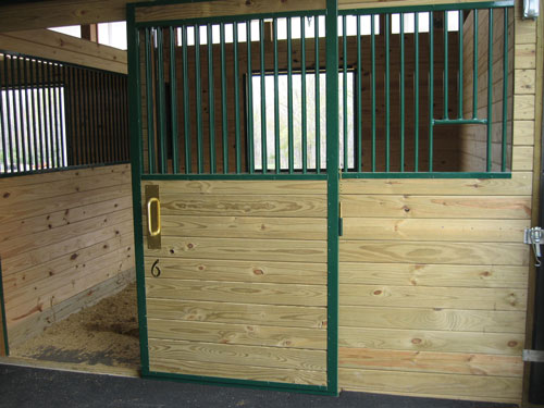 Horse stall front with bars and yoke section in a Blue Chip Structures pole barn