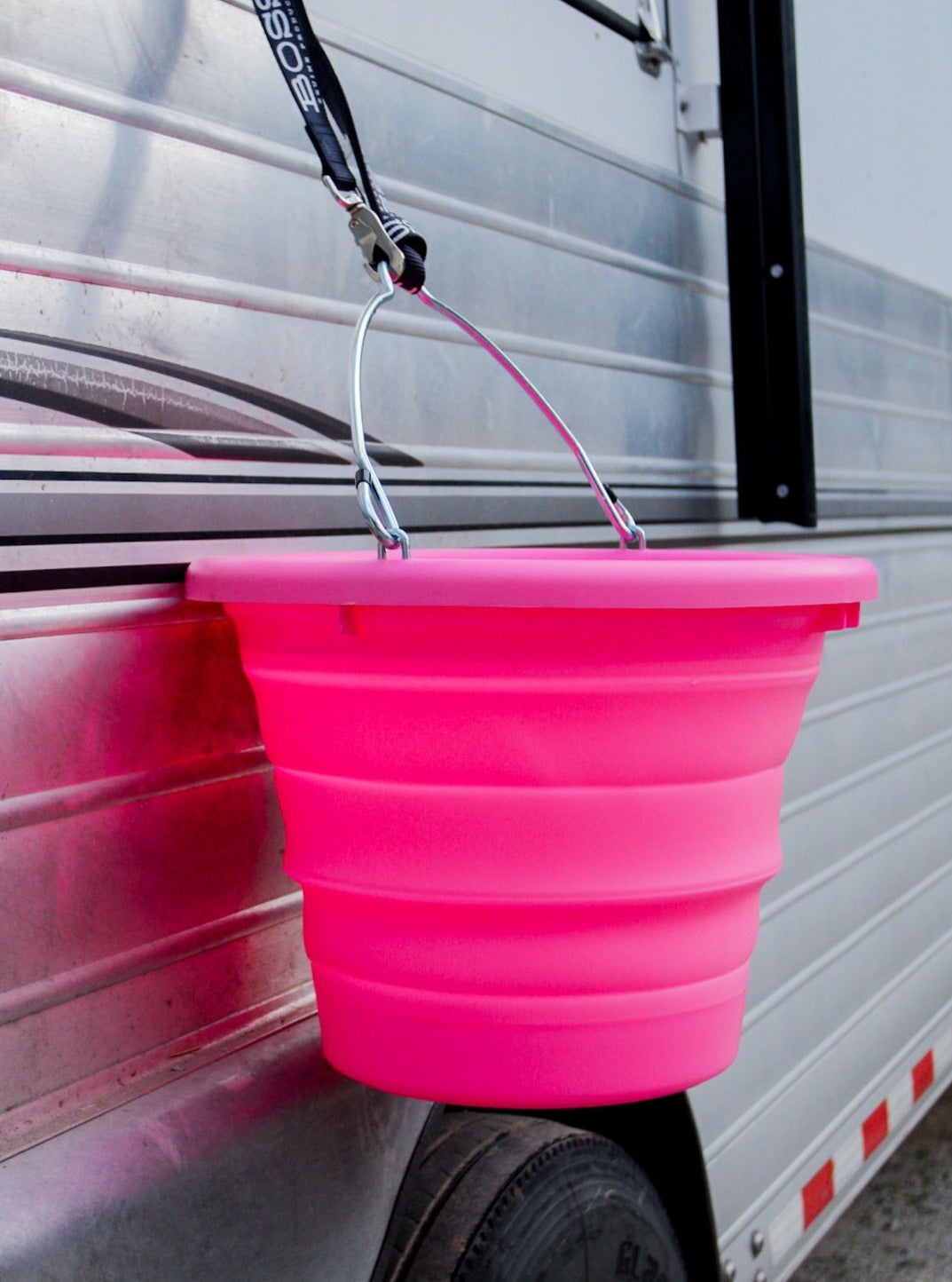 Neon Pink collapsible BOSS Bucket by Boss Equine Products in use at the barn