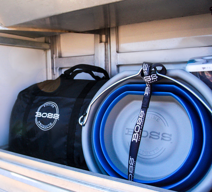 BOSS Bucket and Heavy Duty BOSS Travel Bag set up in a horse trailer manger for hauling