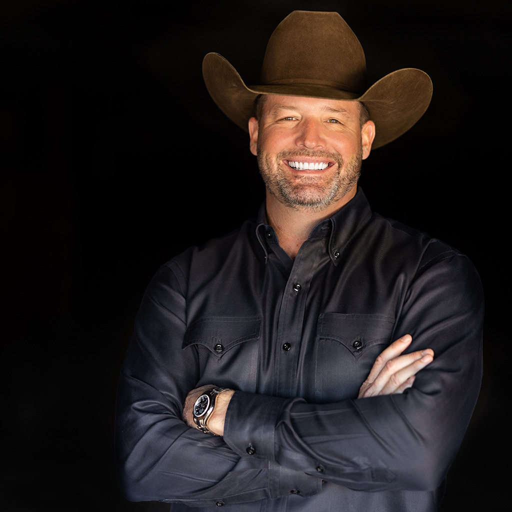 Studio portrait of horseman and clinician Clinton Anderson, founder of Downunder Horsemanship, in a brown cowboy hat