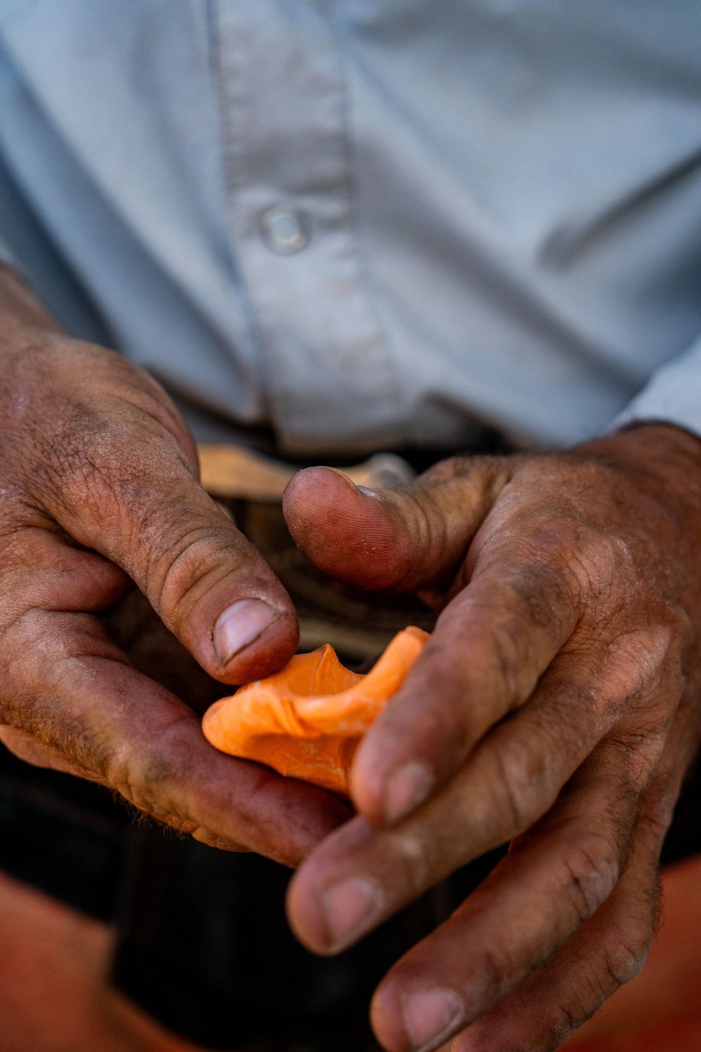 Farrier's hands kneading and mixing a piece of Cloud 9 equine silicone putty before application