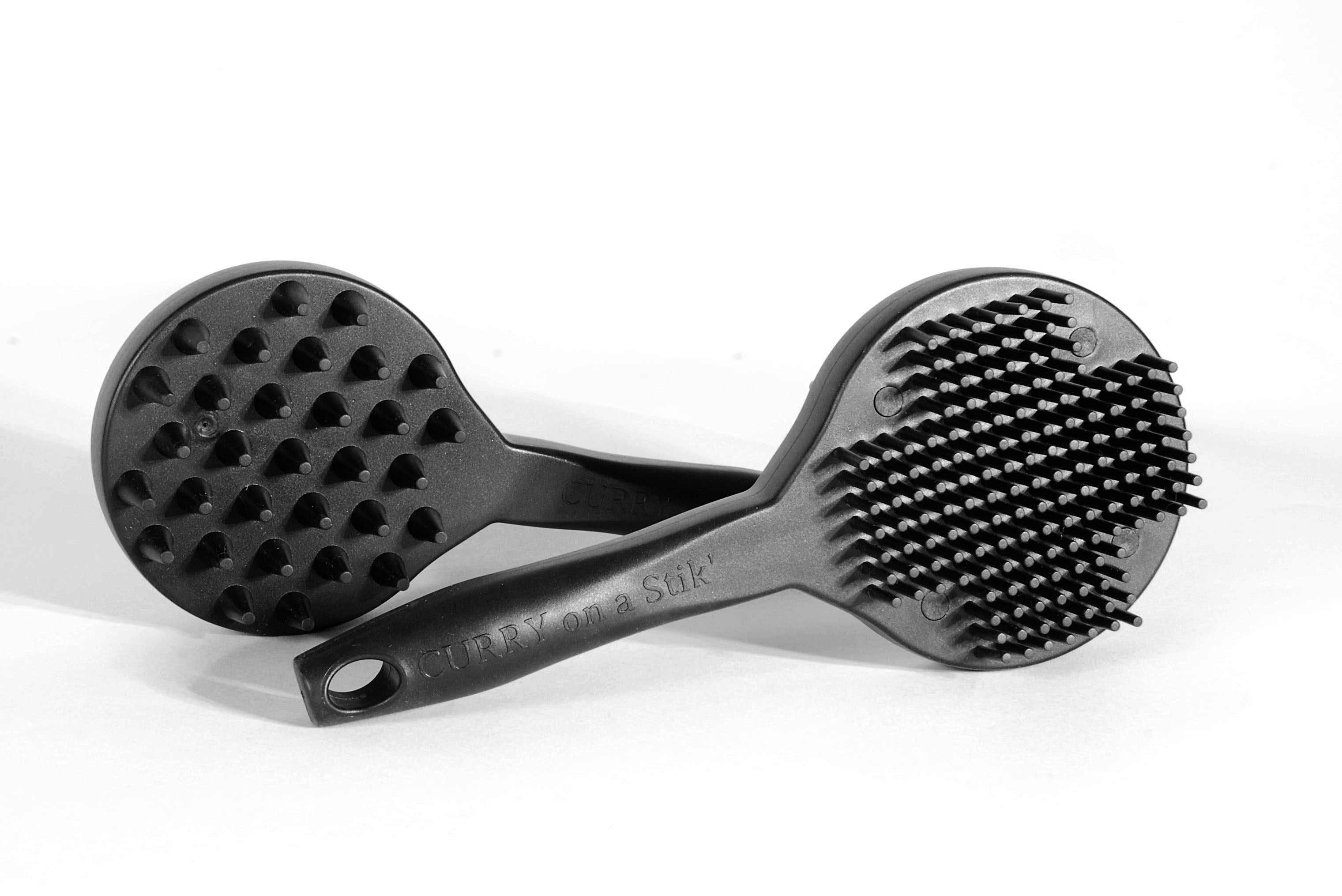 Two Curry on a Stik brushes showing coarse cone teeth and soft fine teeth