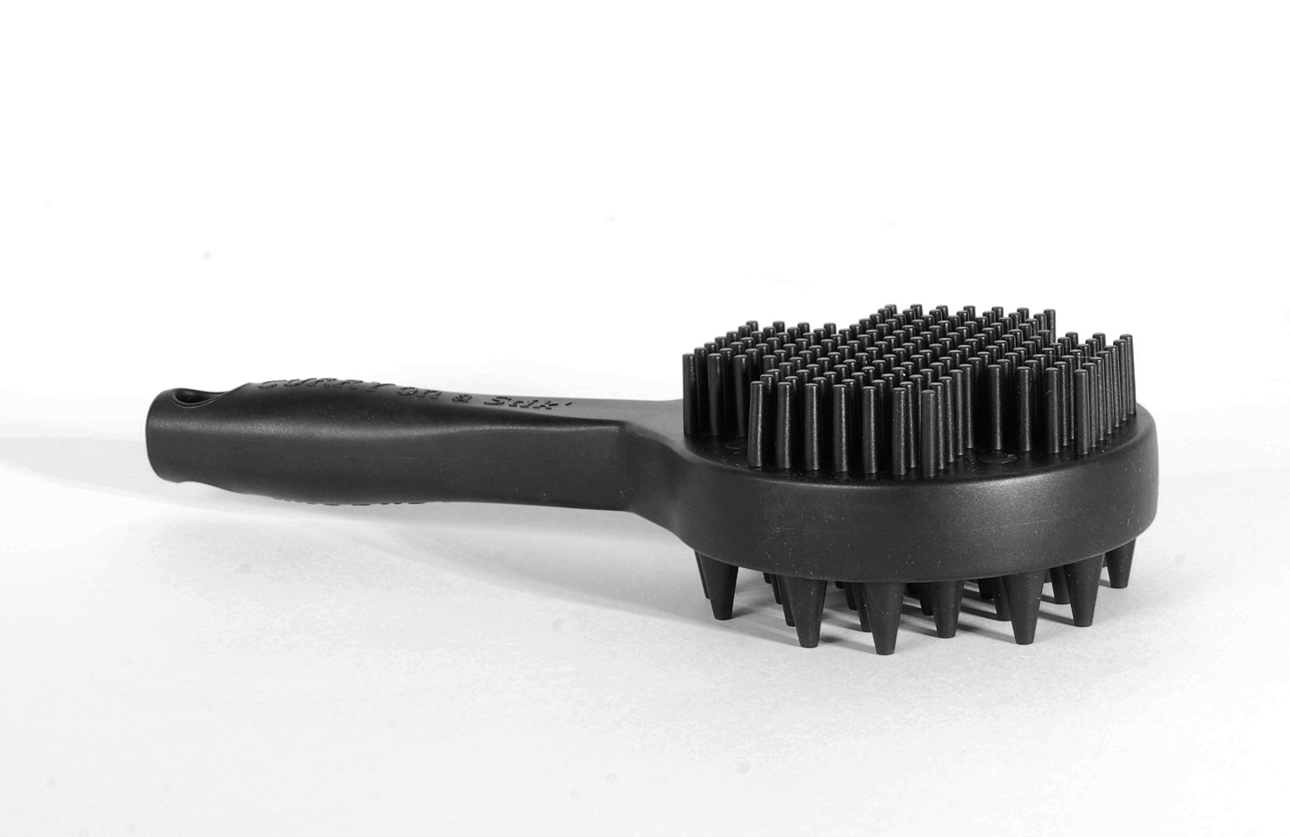Close view of the soft fine-tooth massage side of the Curry on a Stik brush