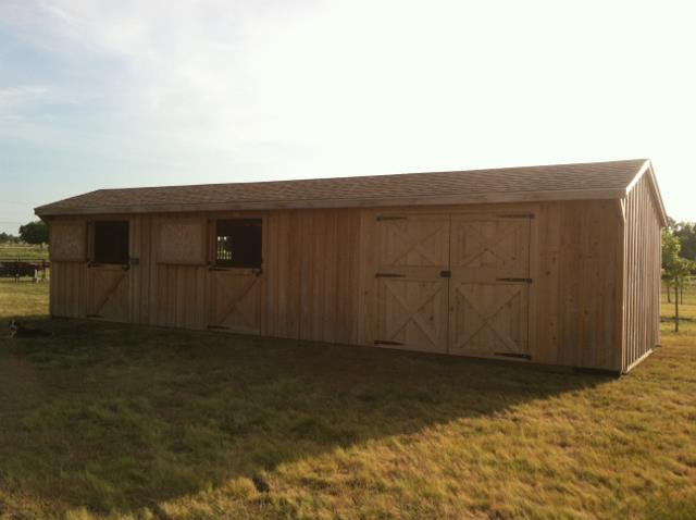 Deer Creek Structures cypress board and batten shedrow horse barn