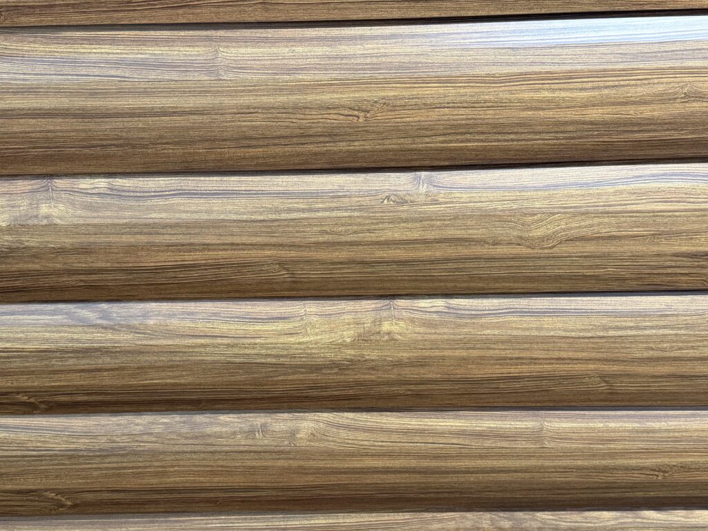 Designer Metals PermaGuard Log Siding Panel wood-look metal siding on a barn exterior