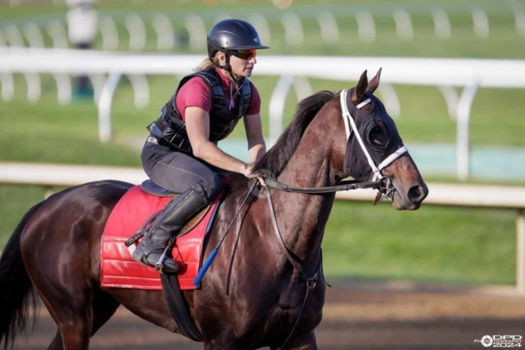 Dream Makers rider galloping a two-year-old racehorse during track training at Keeneland