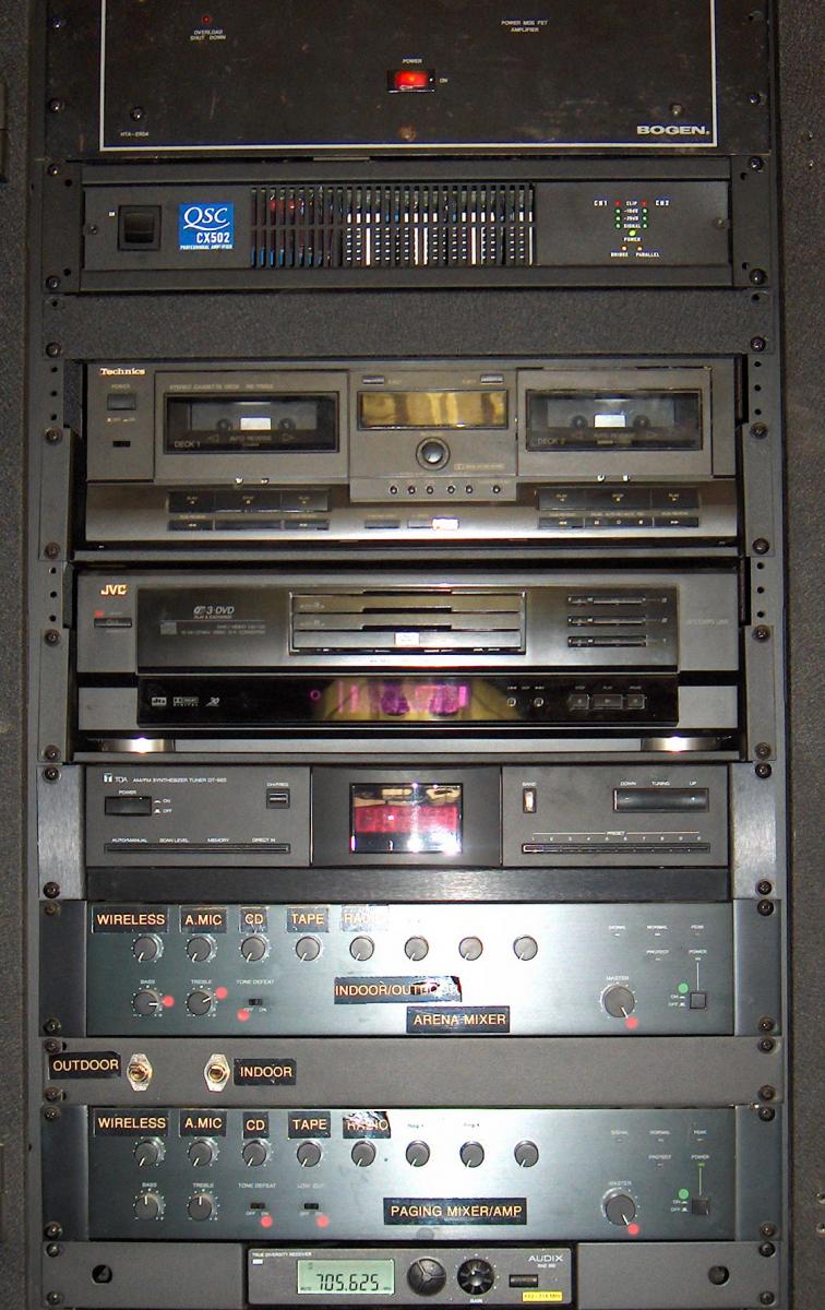 Professional Equine-Audio equipment rack with labeled arena mixer, paging amplifier, and wireless inputs