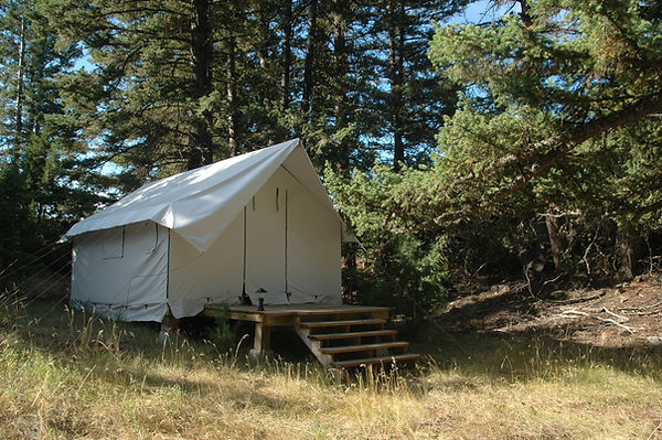 Cabin-style wall tent guest accommodation at Equinisity Retreats Gateway 2 Ranch