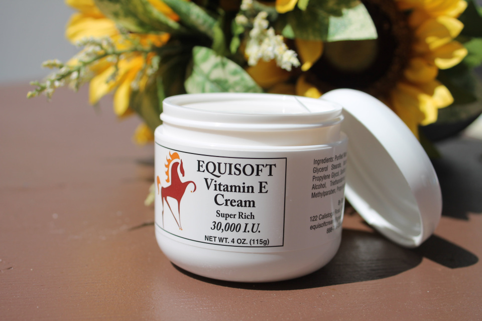 Open jar of Equisoft Vitamin E Cream Super Rich 30,000 IU staged with sunflowers