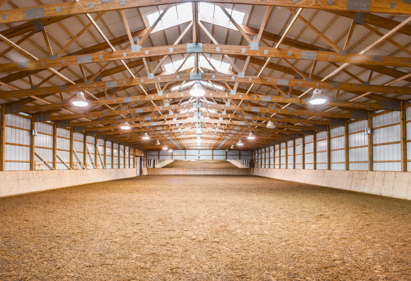 Fibar dust-free wood fiber footing in an indoor horse arena
