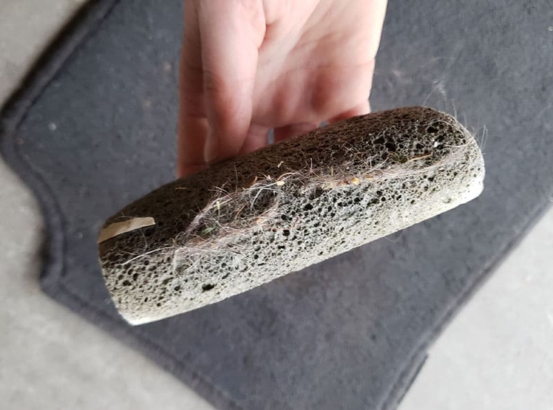 FurzOff stone after sweeping, with pet hair raked up off fabric