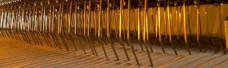 H. Barber & Sons Turf Rake offset raking tines lifting stones onto the perforated conveyor belt