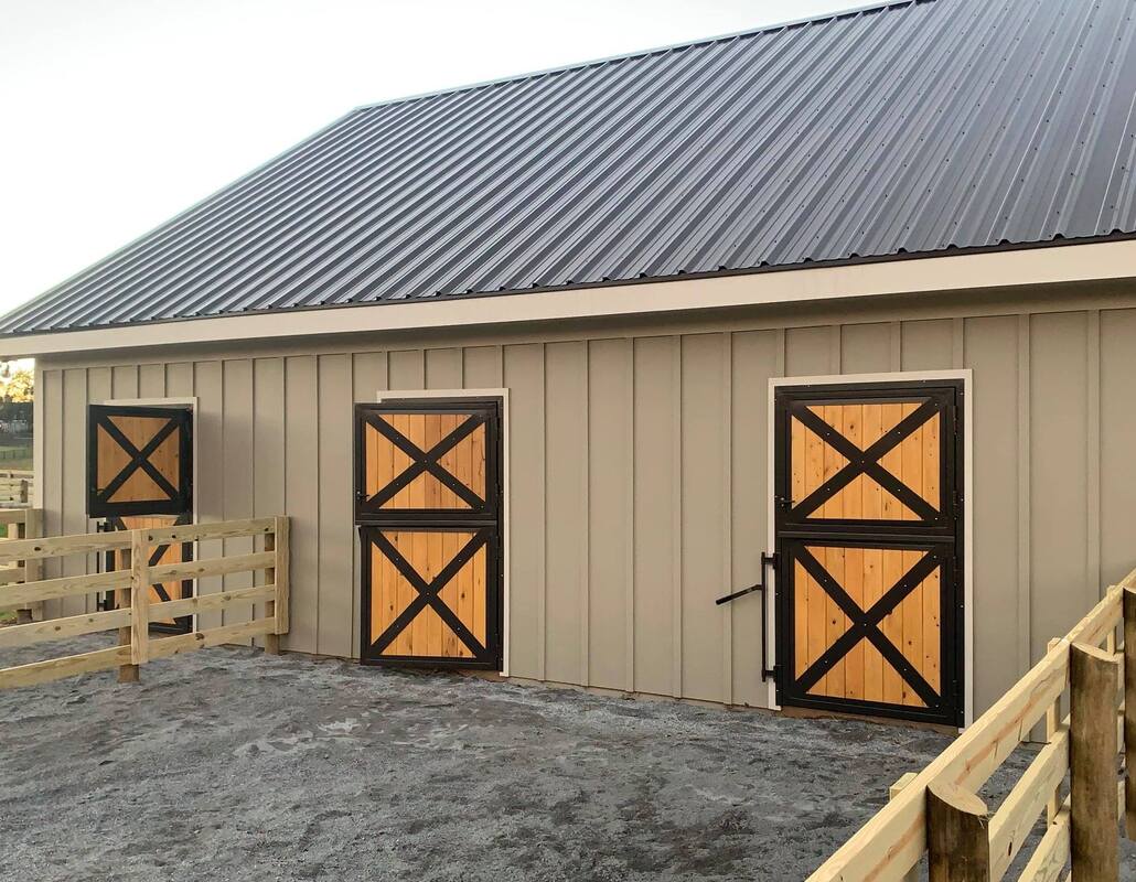 Heritage Equine Equipment custom Dutch door installed on a finished horse barn stall