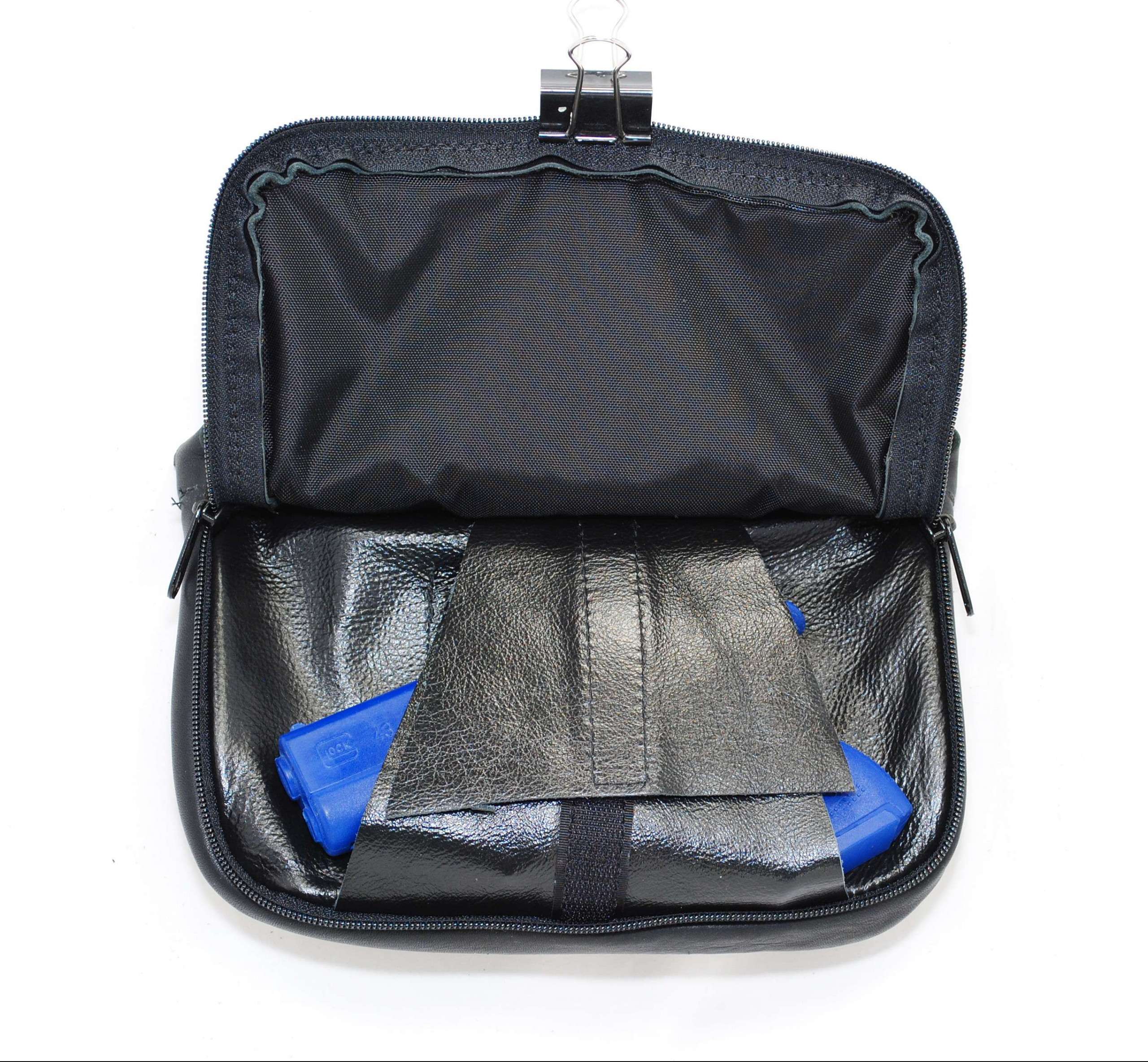 Rear view of Hip Bag Company black leather concealed carry purse showing the zippered rear firearm pocket