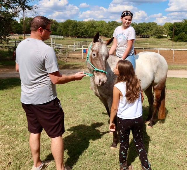 James Swider, Chief Search Strategy Officer at InfoHorse.com, with young riders at the stable