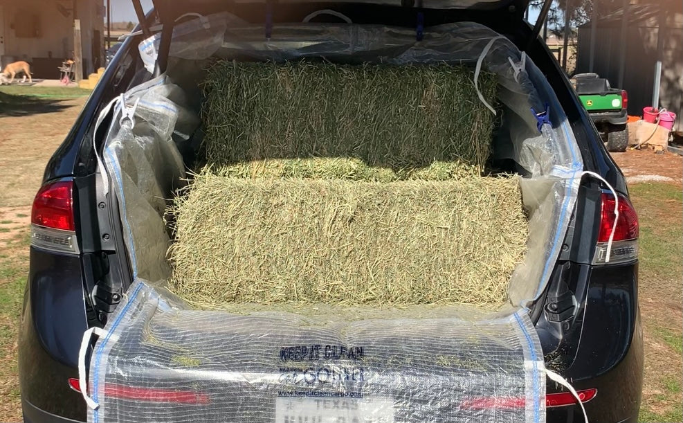 Keep It Clean Cargo Liner loaded with four bales of hay inside an SUV cargo area