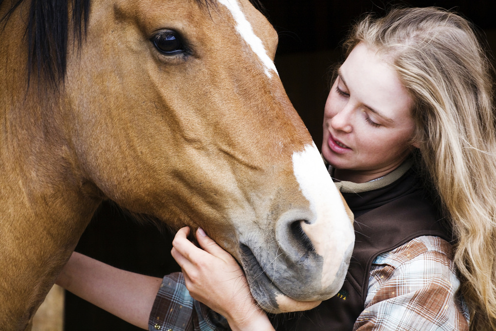 Horse owner cradling her horse's muzzle, reflecting the gentle daily care LaSal nebulizing supports