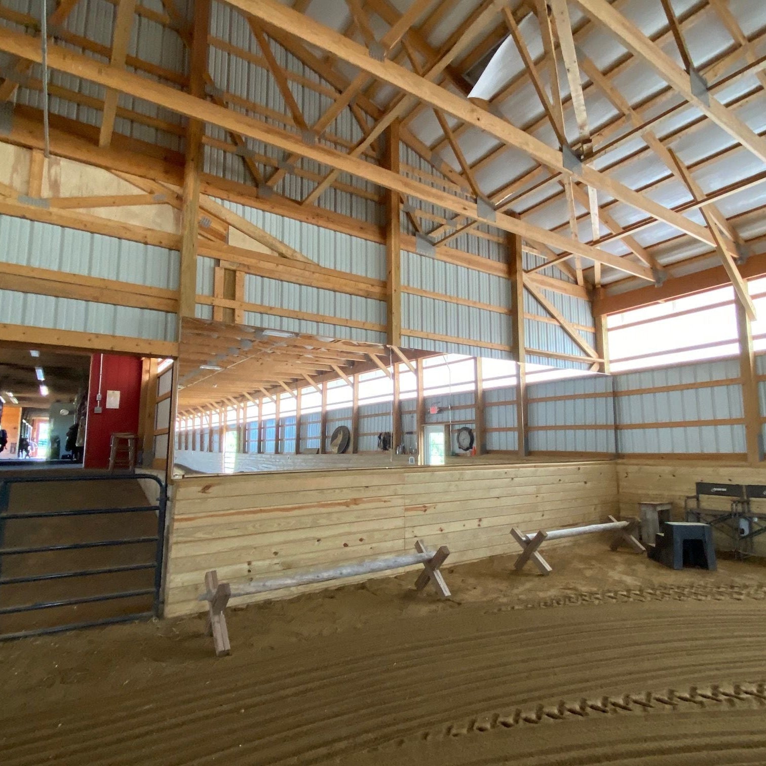 Indoor riding arena wall lined with mounted LiteMirror shatterproof reflective panels
