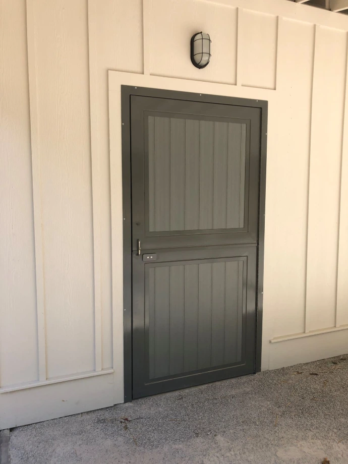 Lucas Equine welded crossbuck Dutch door on a horse barn exterior