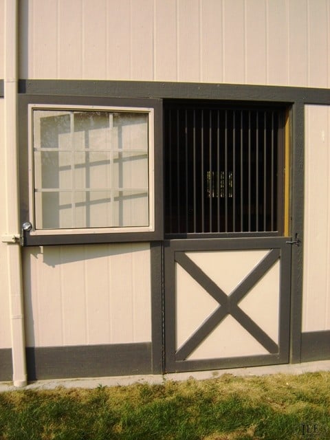 Custom Lucas Equine Dutch door with tempered glass upper panel and steel framing