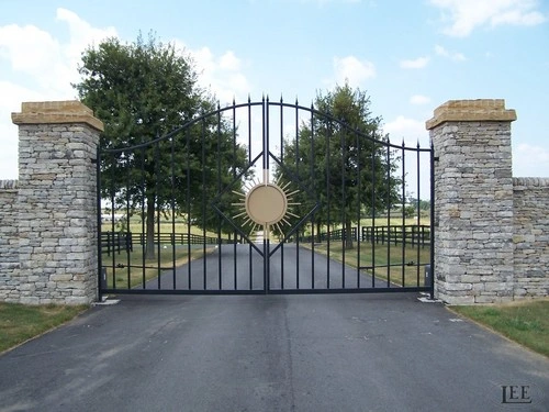 Black ornamental double entrance gates with circular sun medallions by Lucas Equine Equipment