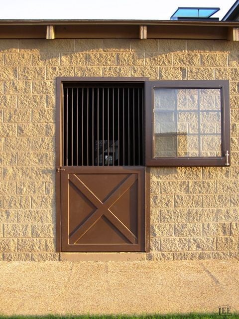 Lucas Equine pre-hung Dutch door with steel-grille upper half on a horse stall