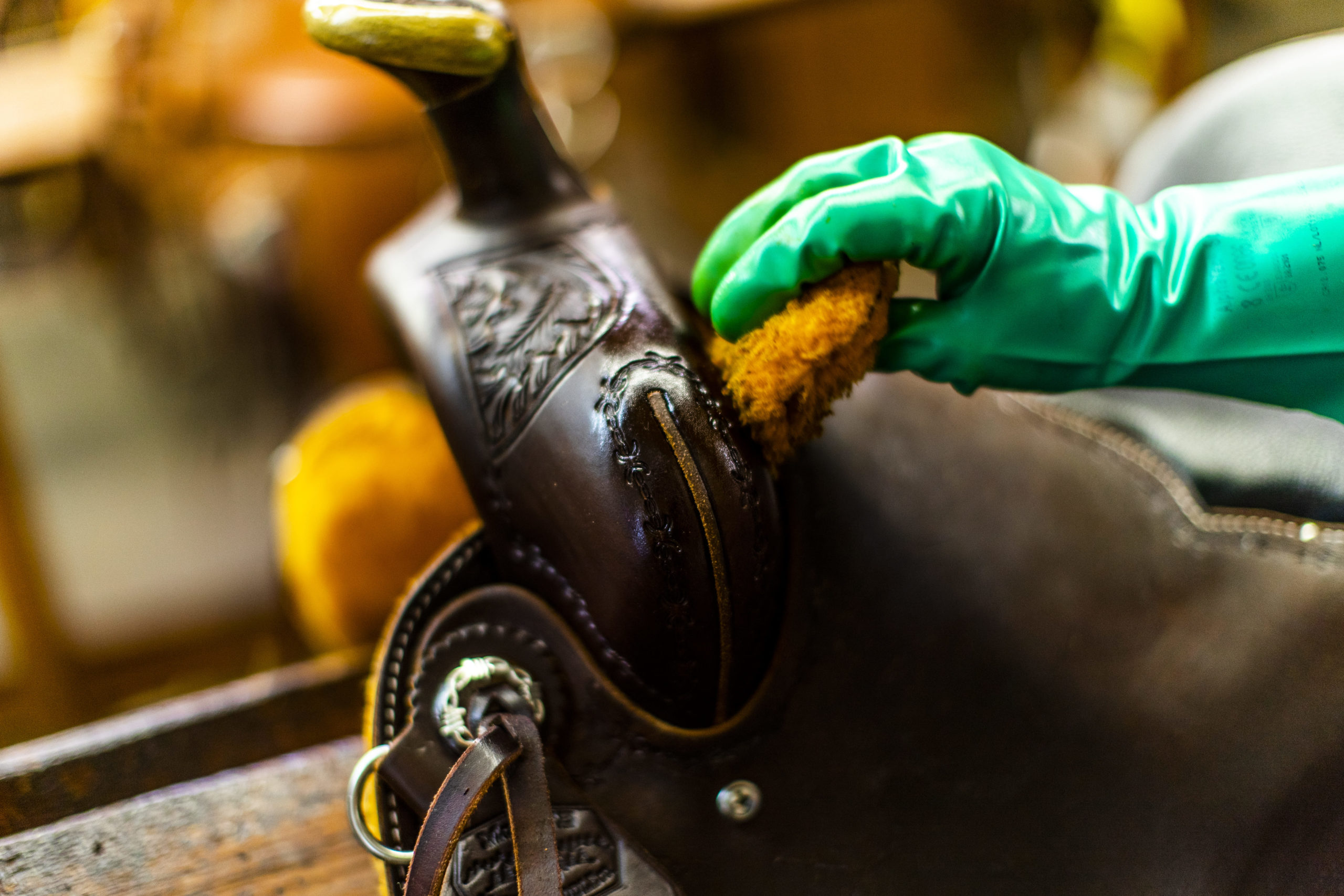 A finished McCall Western saddle receiving a hand-applied coat of neatsfoot oil