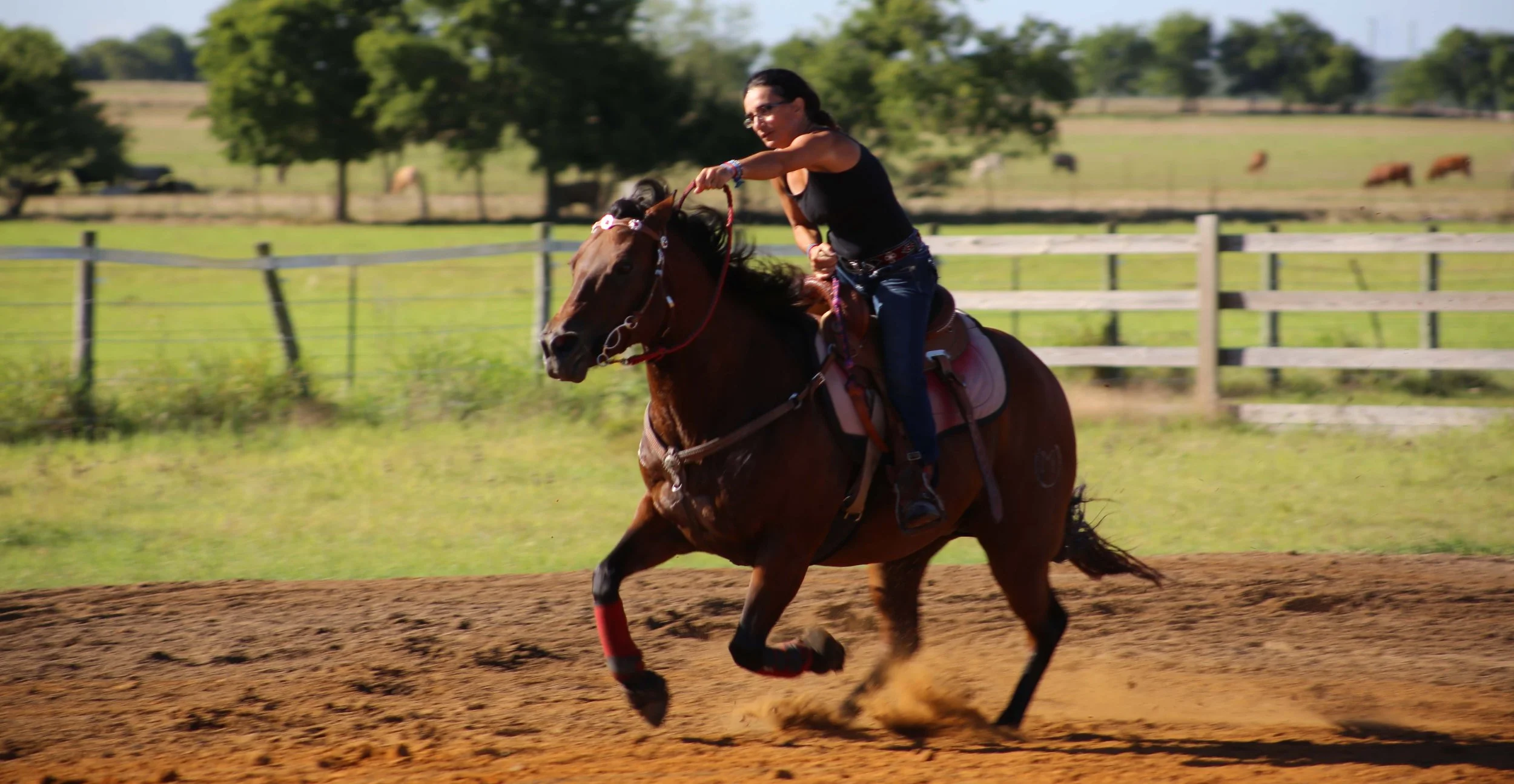 Young rider running the barrel racing pattern at M&M Horse Training Ranch in Georgetown Texas