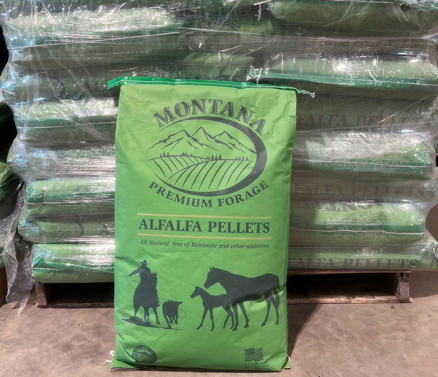 A 40 pound bag of Montana Premium Forage Alfalfa Pellets stacked on a pallet of product