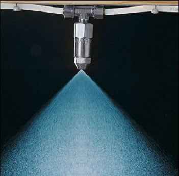 Pro-Tech automatic spray system misting nozzle spraying fly control mist in a horse barn