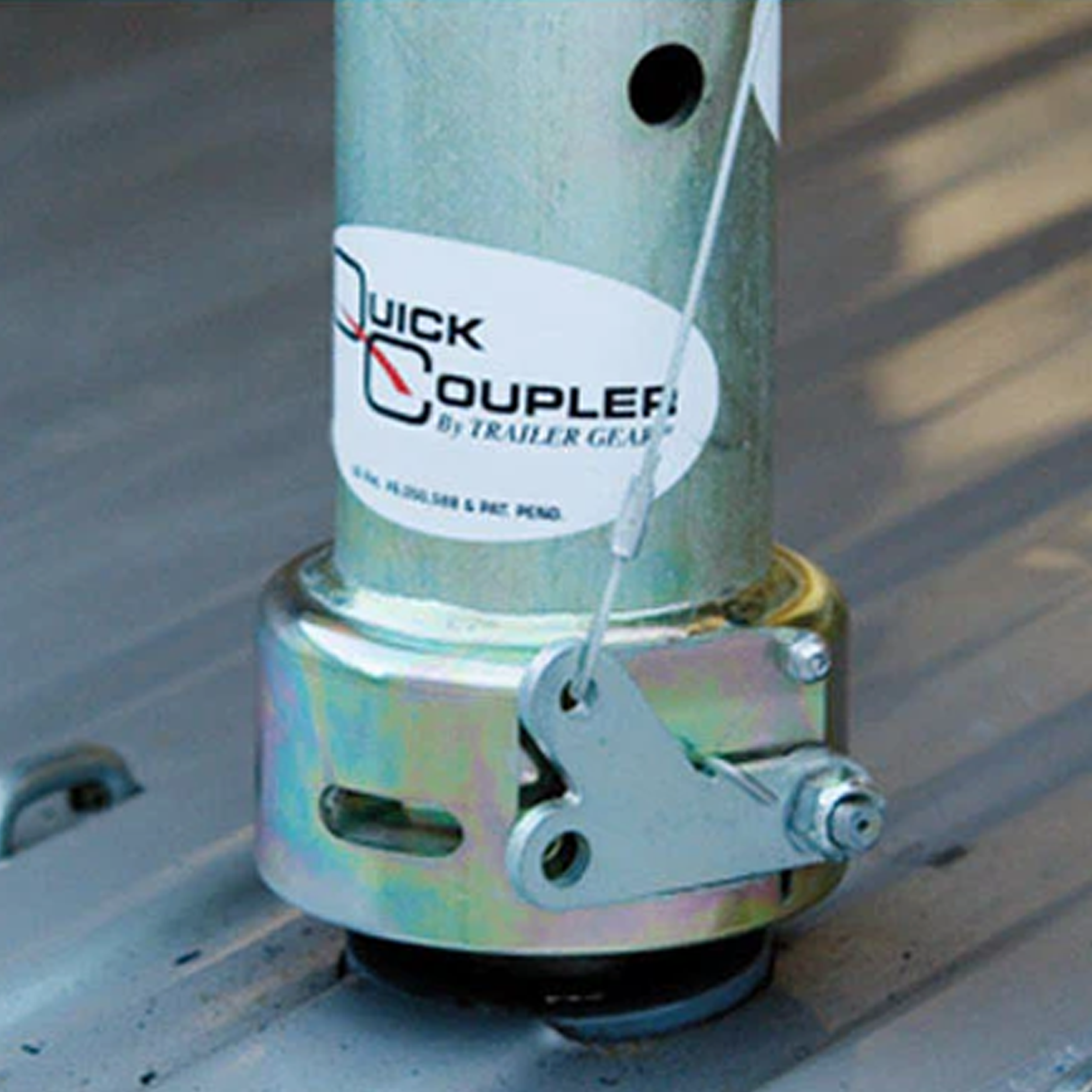 Quick Coupler mounted on a gooseneck trailer with the cable-release locking arm seated over the hitch ball