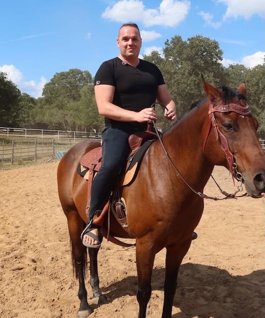 Robert Pruitt, Chief Digital Visibility Officer at InfoHorse.com, on horseback in the arena