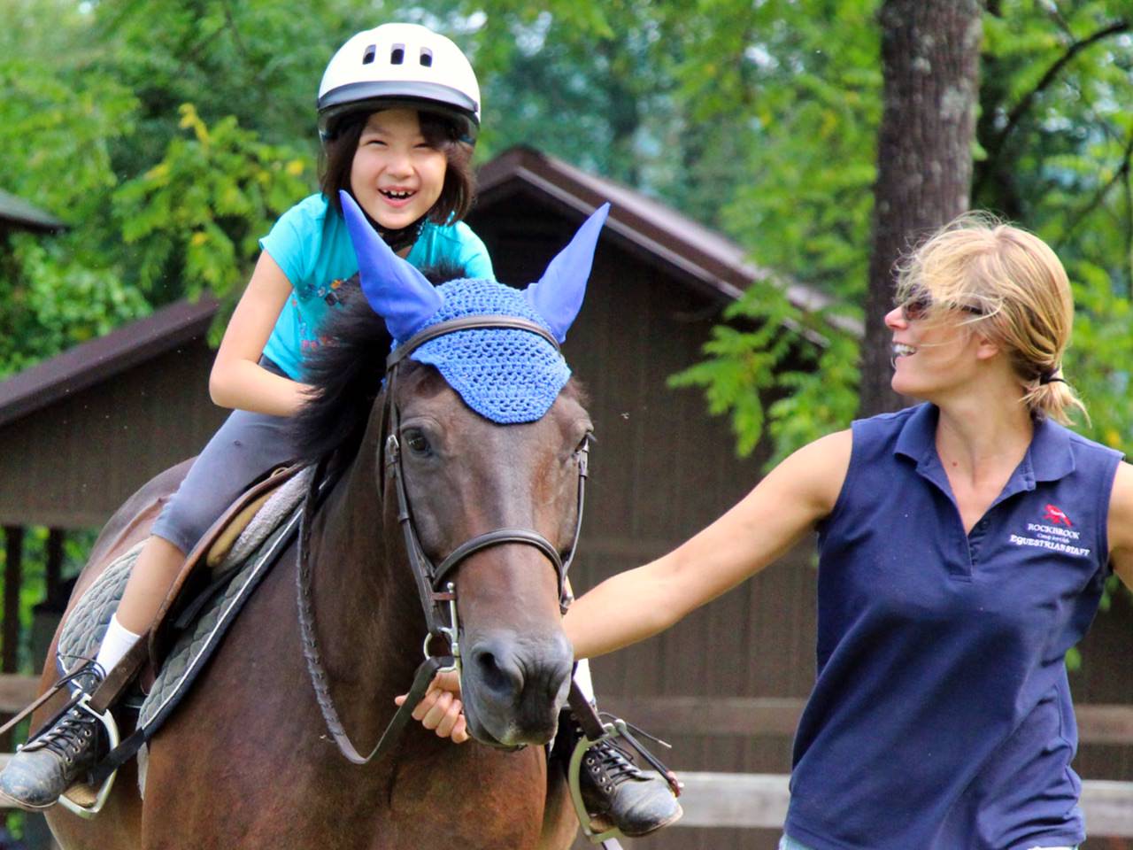 Beginner rider getting English riding instruction at Rockbrook Camp for Girls
