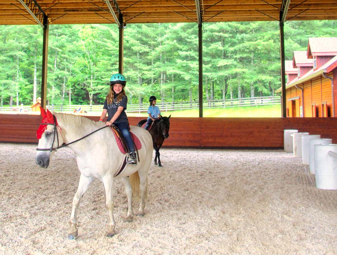Rockbrook covered lighted riding arena with engineered sand and fiber footing