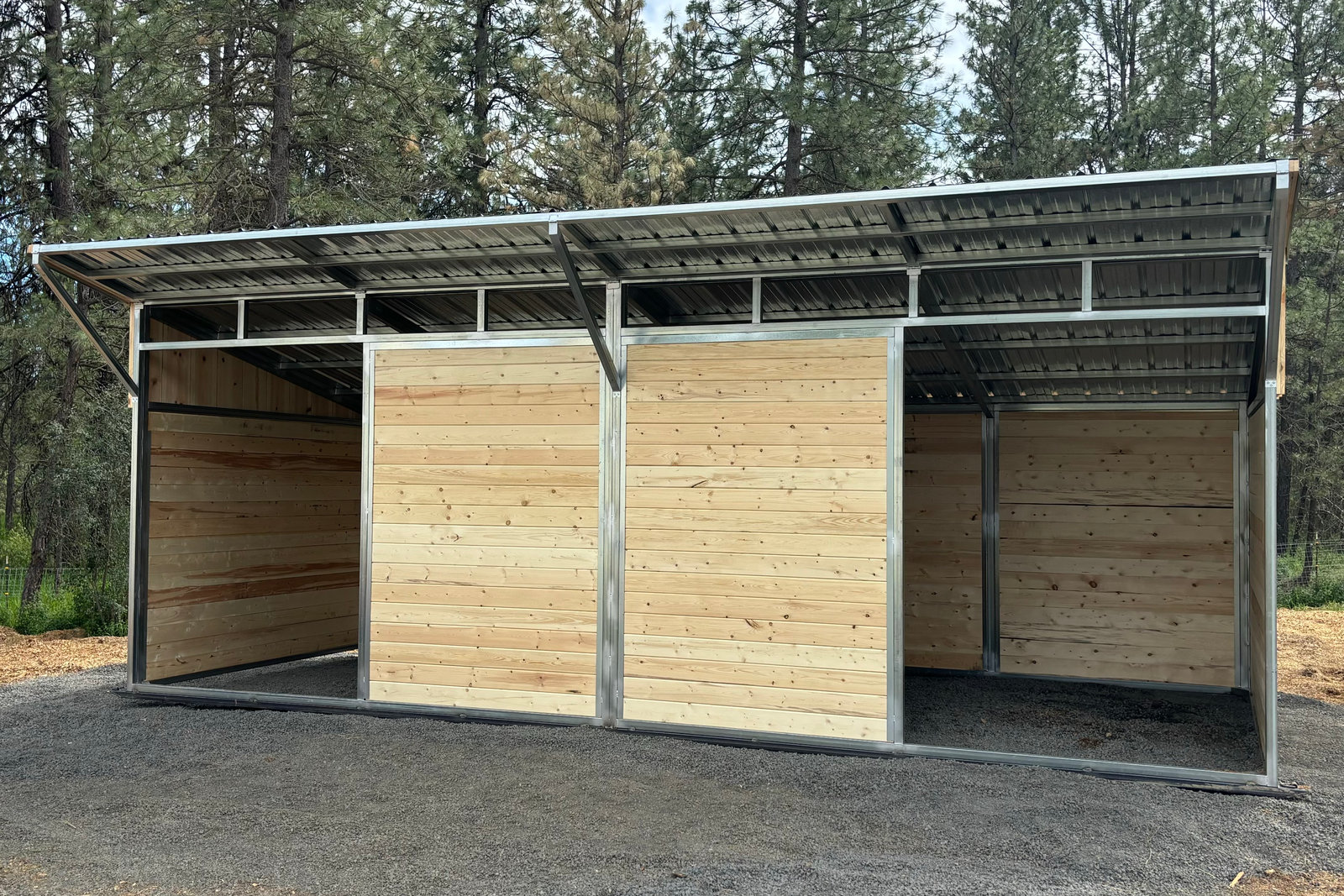 A Selkirk loafing shed with galvanized framing and tongue-and-groove wood, built for turnout shelter