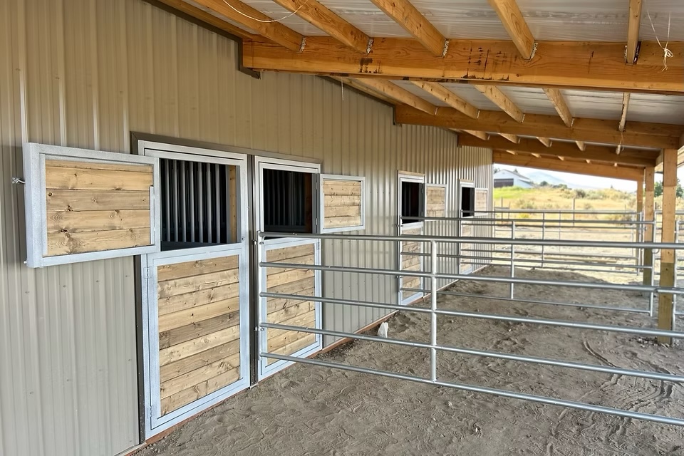 Selkirk Stall Systems paddock doors and stall fronts installed in a working barn, with galvanized panels and wood infill