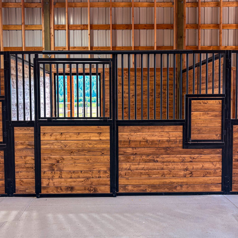 Selkirk stall front with tongue-and-groove wood panels, black steel bars and a feed door
