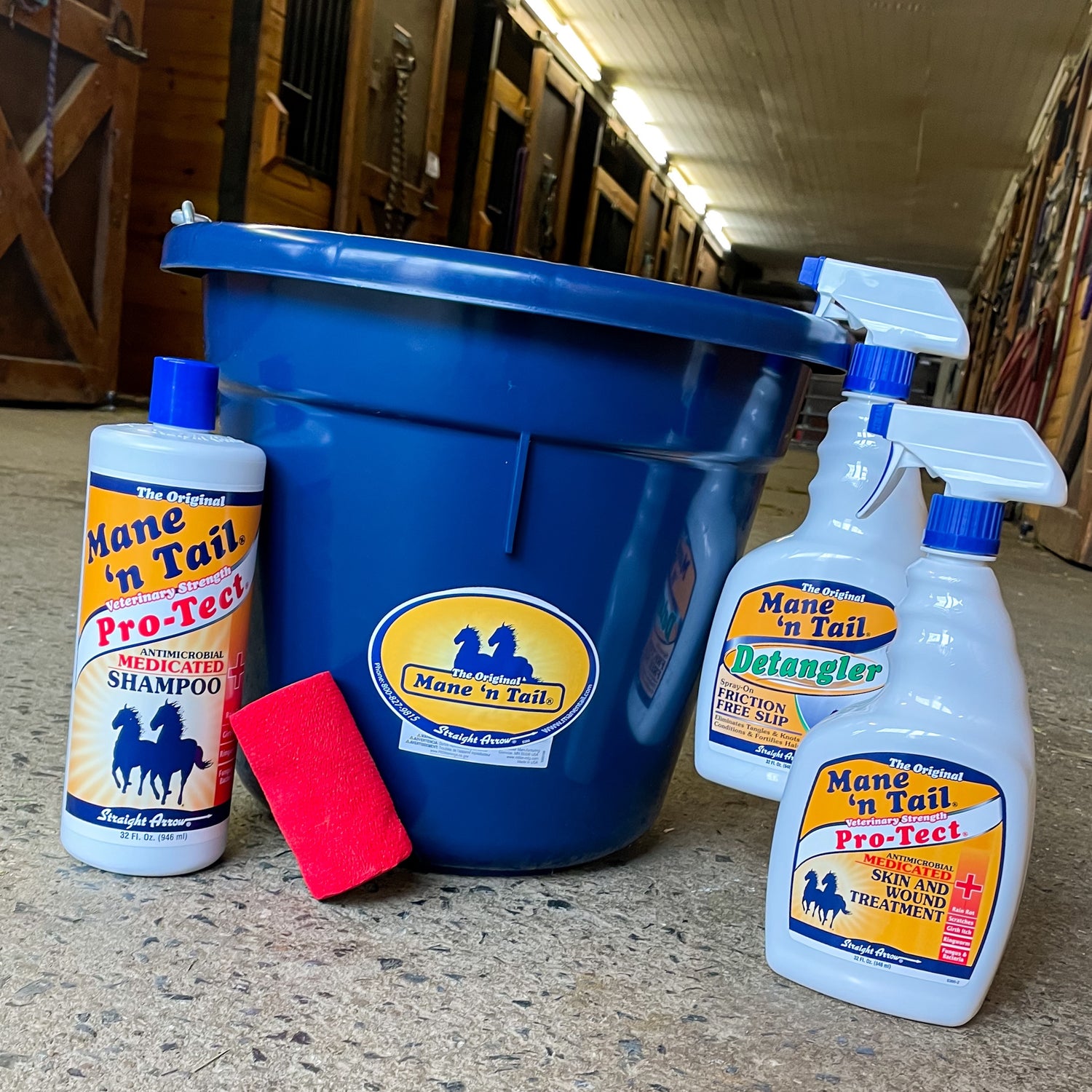 Straight Arrow Mane n Tail equine grooming products lined up in a stable setting