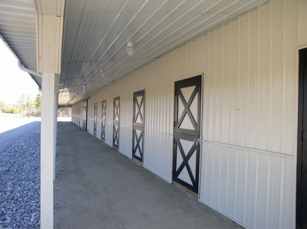 StallWorks 2500 black Dutch doors along a long barn wall