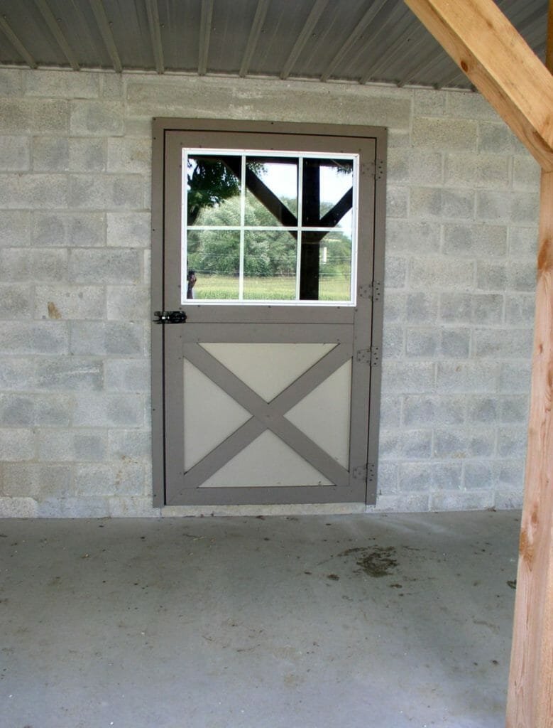 StallWorks model 2520 Dutch door in stone block finish on a stone horse barn