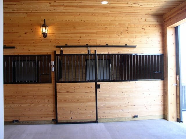 StallWorks stall front featuring a feed hole and grill detail in powder-coated steel
