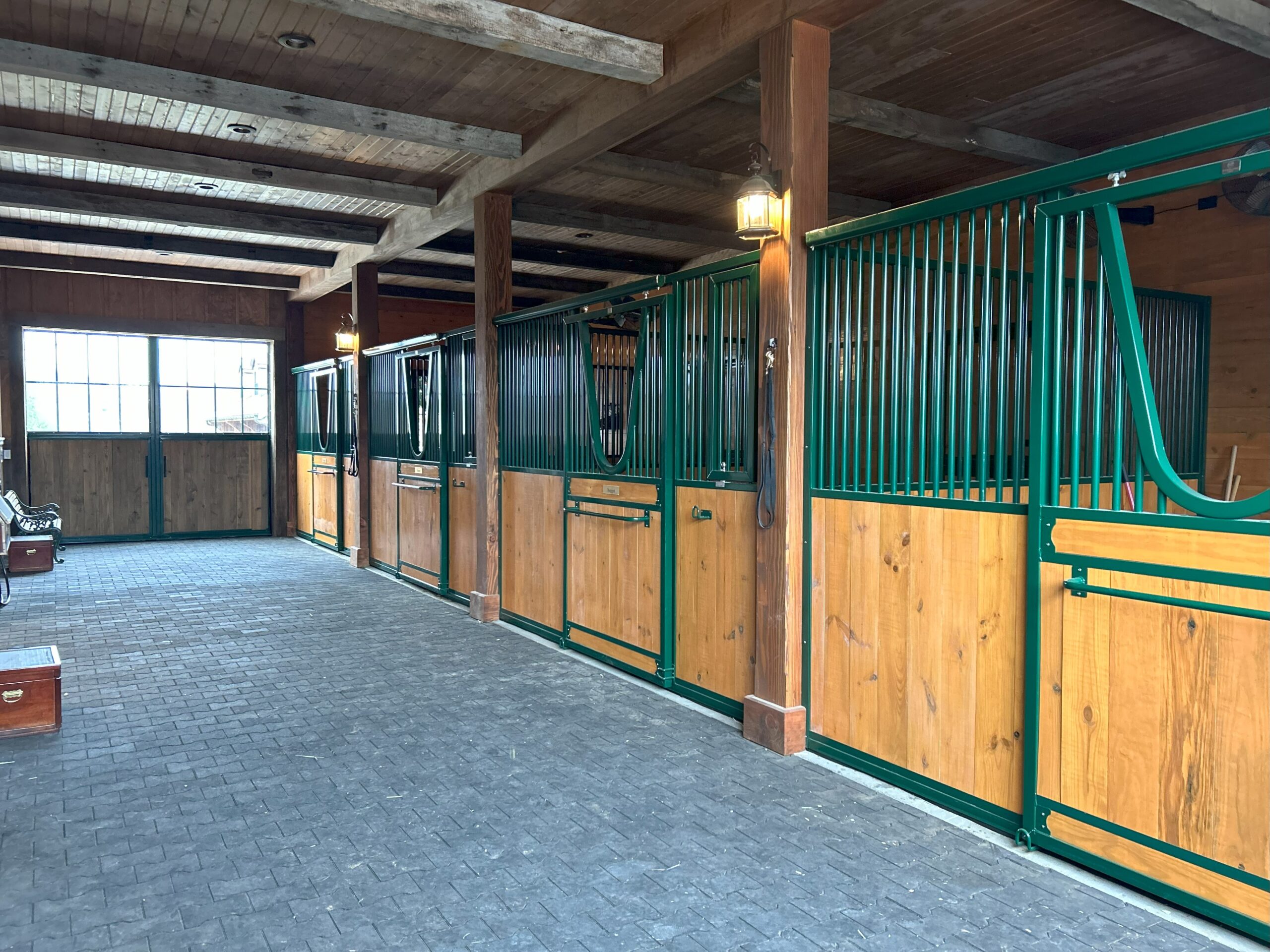 Sterling-Equine sliding stall doors with yoke openings in a custom horse barn