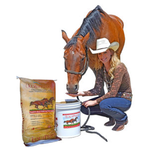 Rider holding a 50 lb bag of SweetPro EquiPride horse supplement